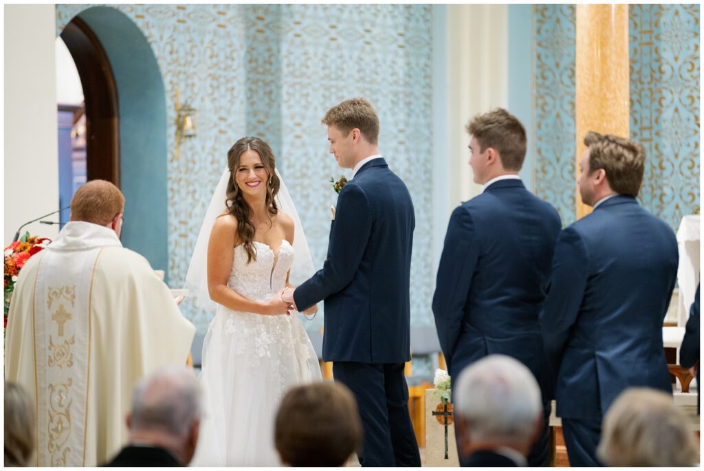 Bride and Groom at the altar saying their vows at St. Monica's Catholic Church