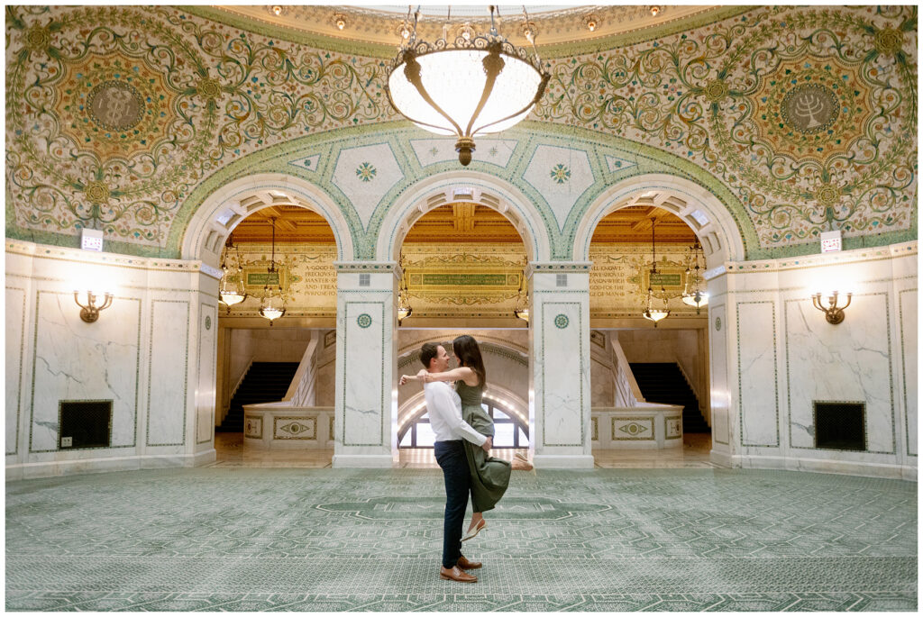 Chicago Cultural Center engagement photos with couple embracing under stunning Tiffany dome and ornate ceiling