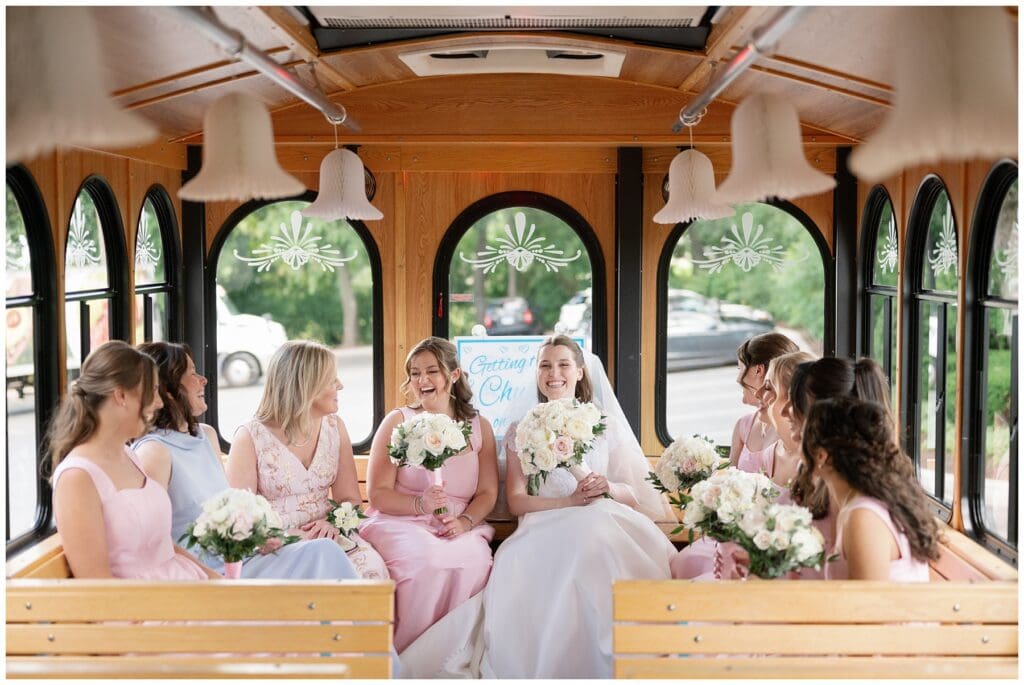 Bride and bridesmaids ride the wedding trolley to the Catholic ceremony before their Hinsdale Golf Club wedding in Clarendon Hills.