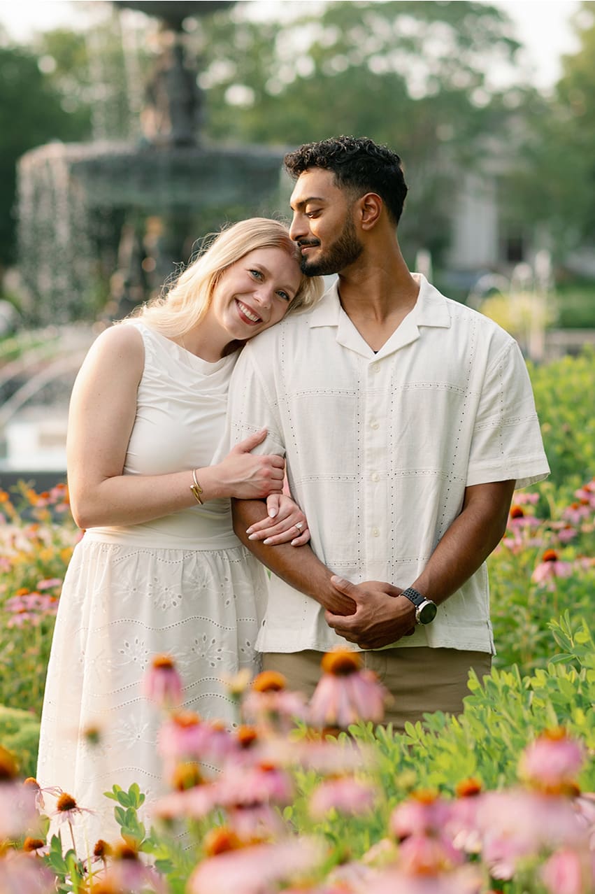 Leeper Park Engagement Photos with a couple in front of a fountain with pink coneflowers surrounding them