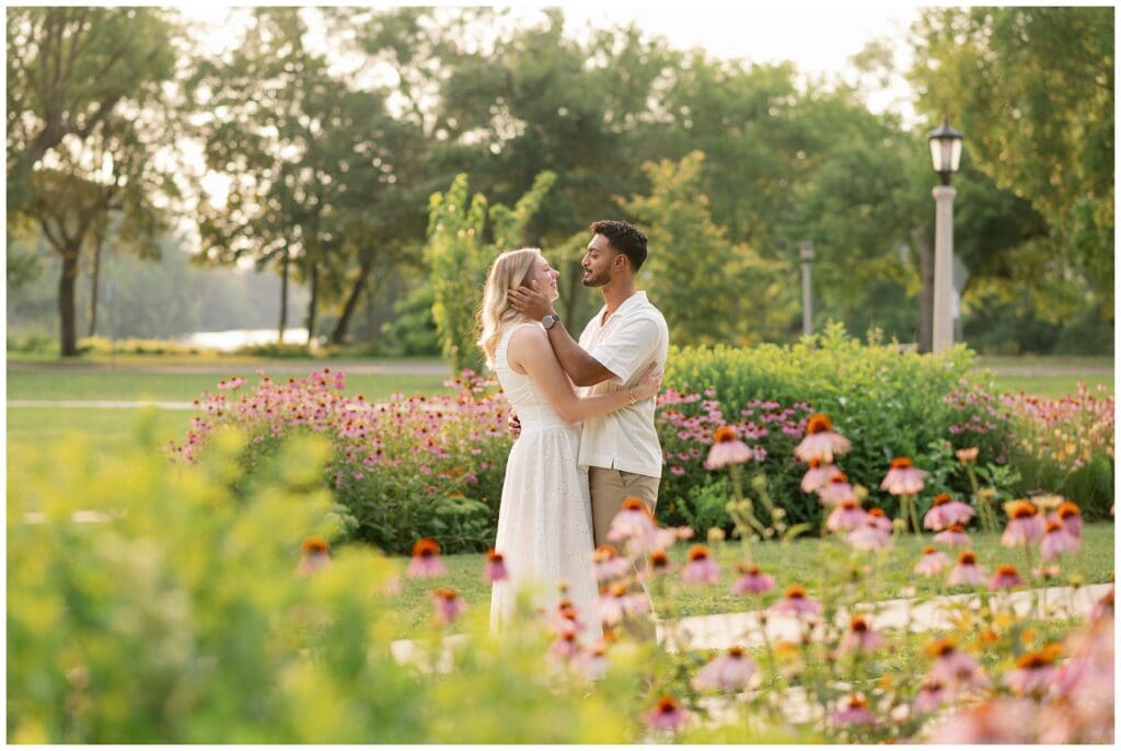 Anna and Solu sharing a quiet moment surrounded by blooming coneflowers at Leeper Park.