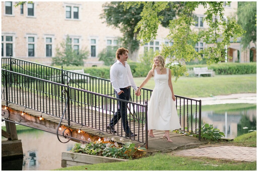 Katie and Chris holding hands on a bridge during their Saint Mary’s College engagement photos